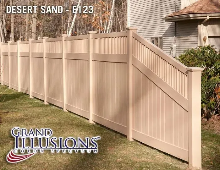 Desert sand-colored vinyl fence in a grassy yard. 