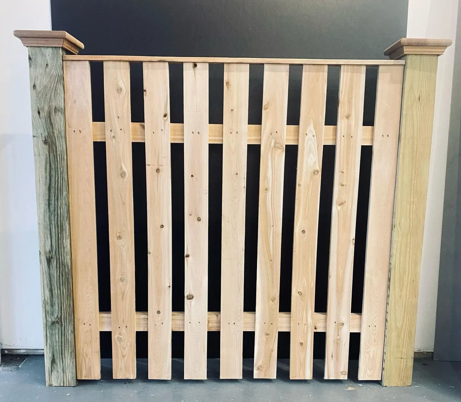 Wooden fence panel with vertical planks between two posts.