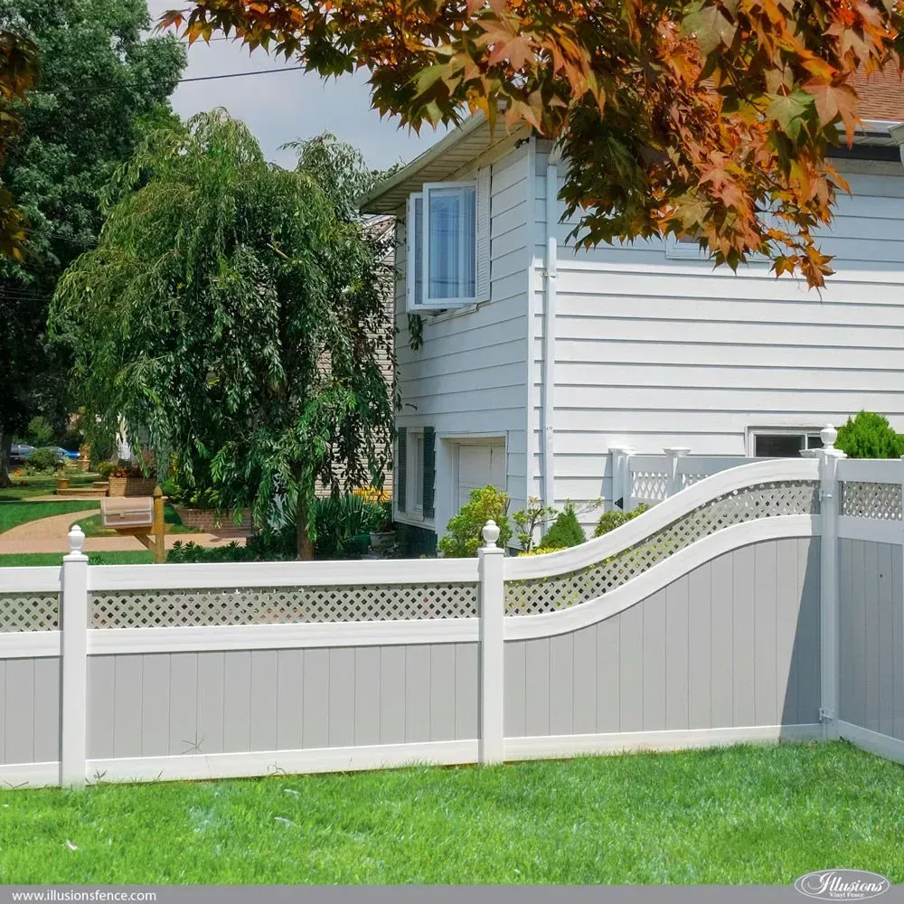 White and grey vinyl fence in front of a white house with a green lawn.