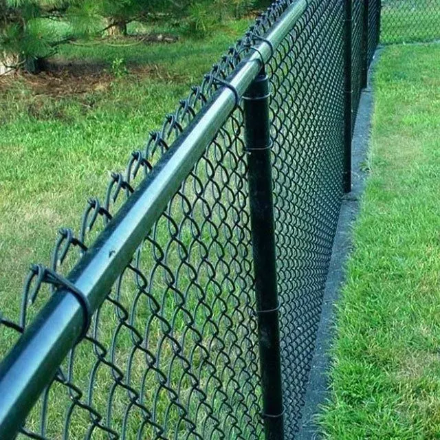 Black chain-link fence bordering a lawn. Green grass, dark posts and top rail.